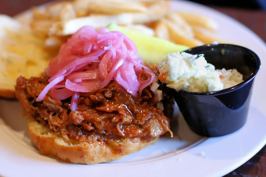 Pulled Pork Sandwich with a side of cole slaw and fries at Harts Tavern in Peddlers Village
