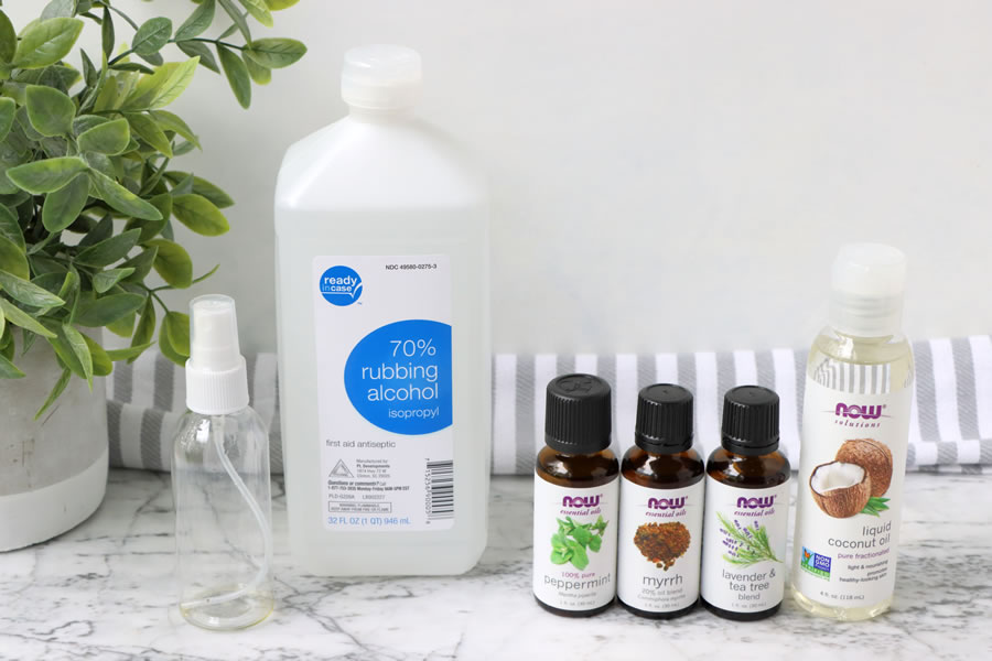 Ingredients to make Protect & Defend! DIY Hand Sanitizer recipe with 70% rubbing alcohol, peppermint essenial oil, myrrh essential oil, lavender and tea tree essential oil, coconut oil and a small spray bottle