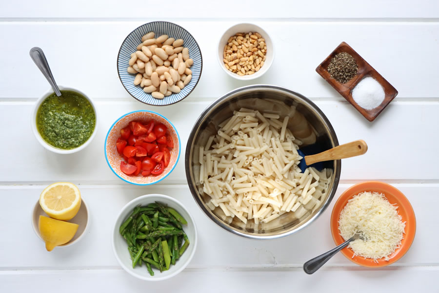 tomatoes, cannellini beans, pine nuts, parmesan cheese, lemon, asparagus, Ingredients laid out for the chicken pesto pasta