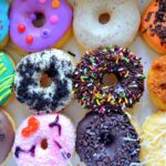 A vibrant selection of decorated donuts from Philadelphia with various toppings, perfect for festive occasions