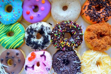 A vibrant selection of decorated donuts from Philadelphia with various toppings, perfect for festive occasions