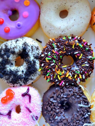 A vibrant selection of decorated donuts from Philadelphia with various toppings, perfect for festive occasions