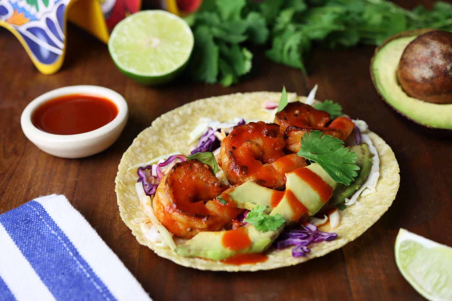 honey sriracha shrimp tacos on a table with ingredients