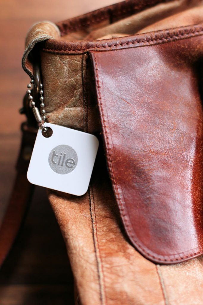 Tile Bluetooth Tracker attached to a bag
