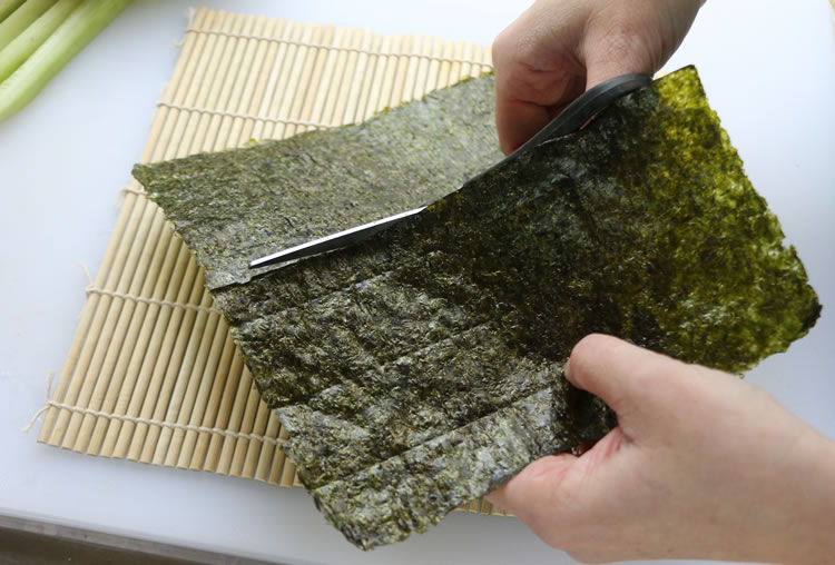 cutting nori sheets for making sushi 
