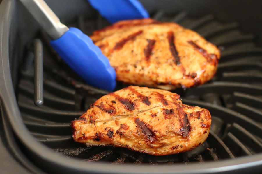 Grilled chicken breasts being cooked in the Ninja Foodi Grill