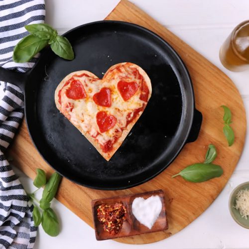 heart shaped low carb tortilla pizza with heart shaped pepperoni.