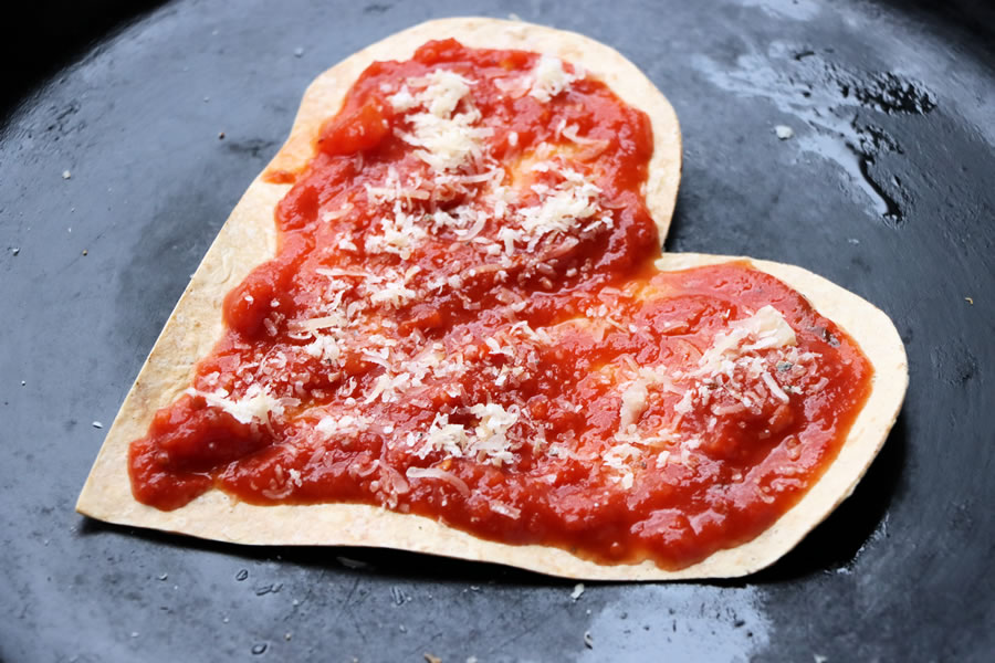 Low-carb heart-shaped crust topped with sauce and parmesan cheese