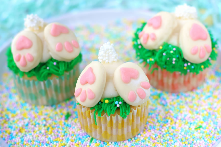 three bunny butt cupcakes on sprinkles
