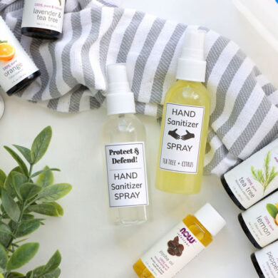 DIY Hand Sanitizers displayed next to essential oils of orange tea tree lemon and peppermint