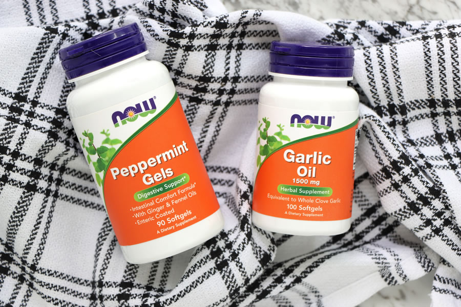 NOW Peppermint Gels and Garlic oil supplements on a plaid towel
