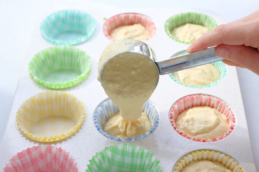 adding cupcake mix to the pan