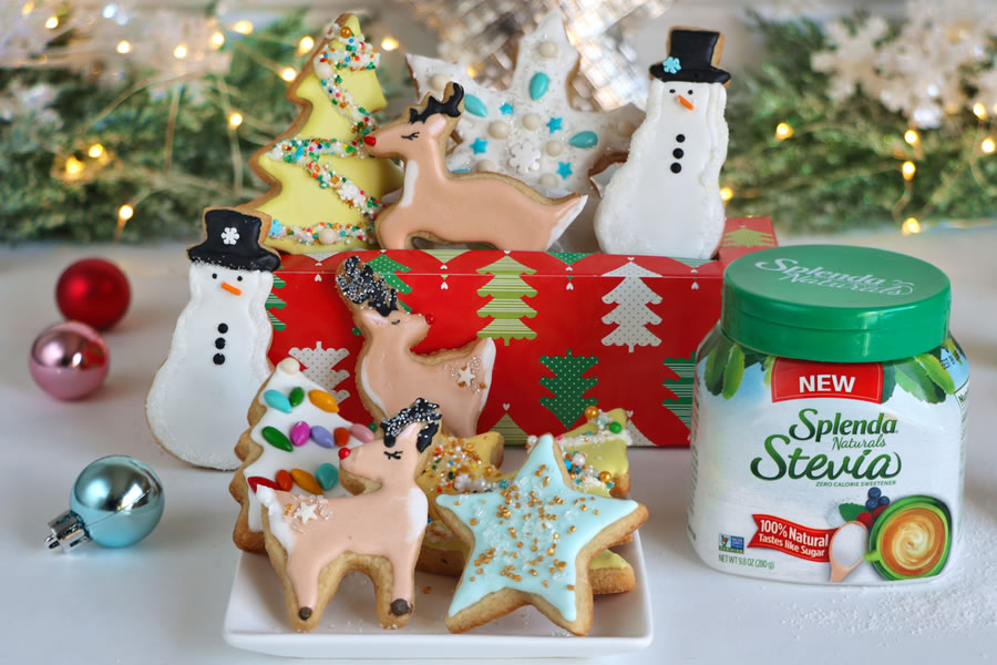Christmas cookies decorated next to Splenda Naturals Stevia with lights and ornaments