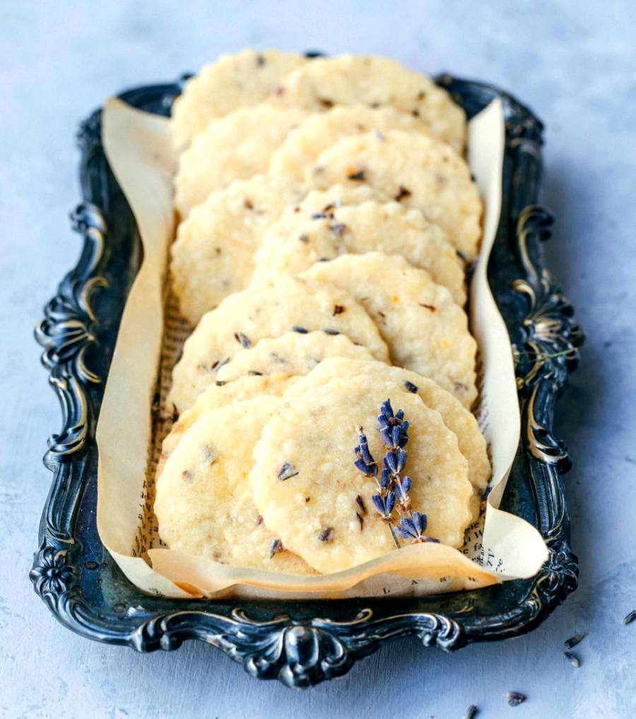 lavender shortbread cookies arranged on a scrolled rectangular antique plate with lavender sprigs