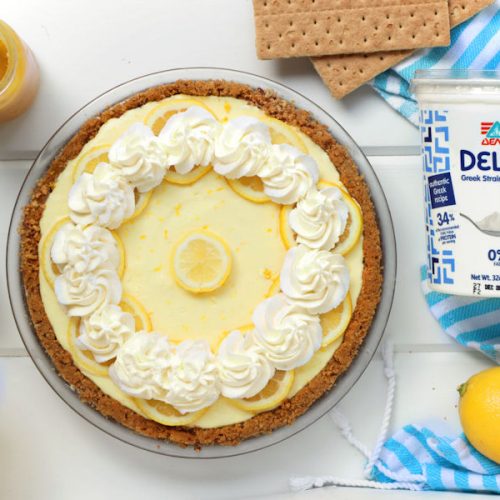 Greek Yogurt Lemon Cream Pie made with Delta Greek yogurt and decorated with lemon slices and whipped cream| onbetterliving.com