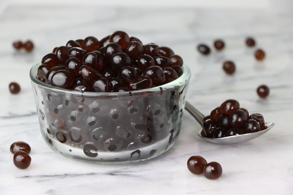 Health boba tea pearls in a glass bowl with a spoon