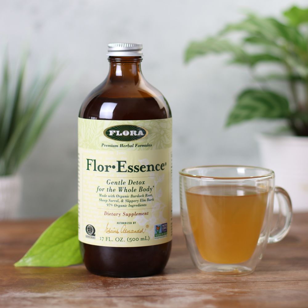 A bottle of Flor-Essence next to a full mug of tea.