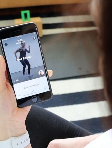 A woman using the Future Fitness app on her phone.