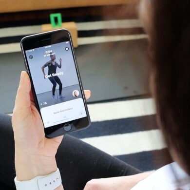A woman using the Future Fitness app on her phone.