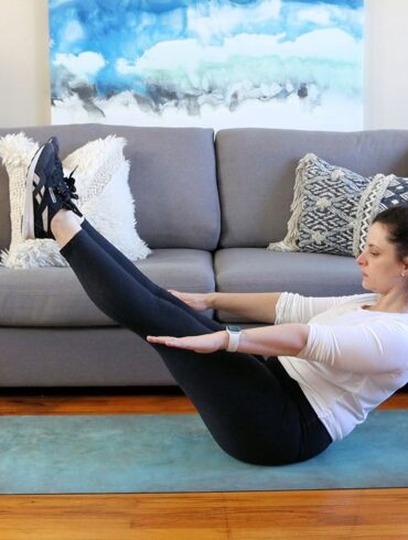 A woman doing yoga at home with a fitness app