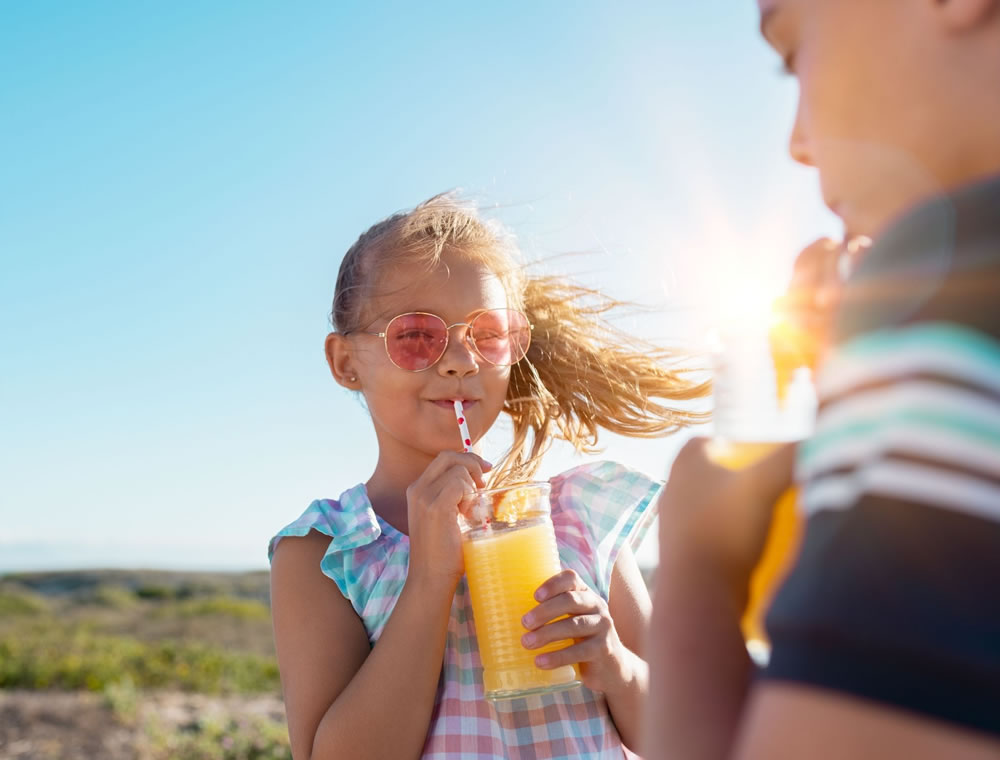 Children drinking a multivitamin