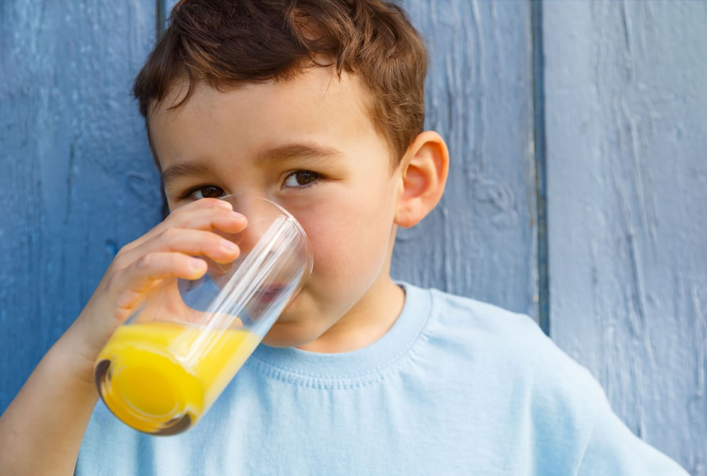 Child drinking a multivitamin