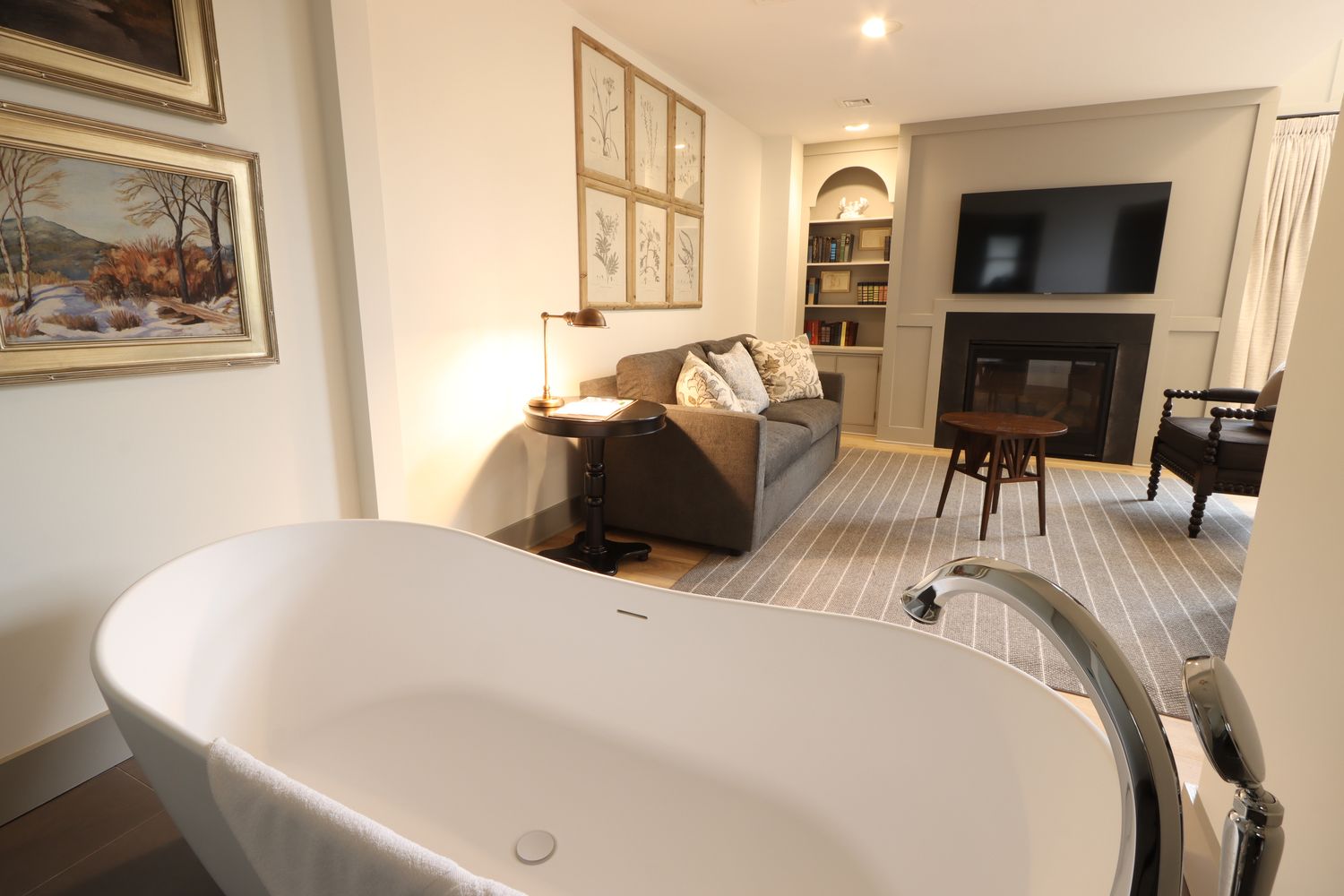 A large soaking tub with a view of the living area in Room 110 at The Golden Plough Inn