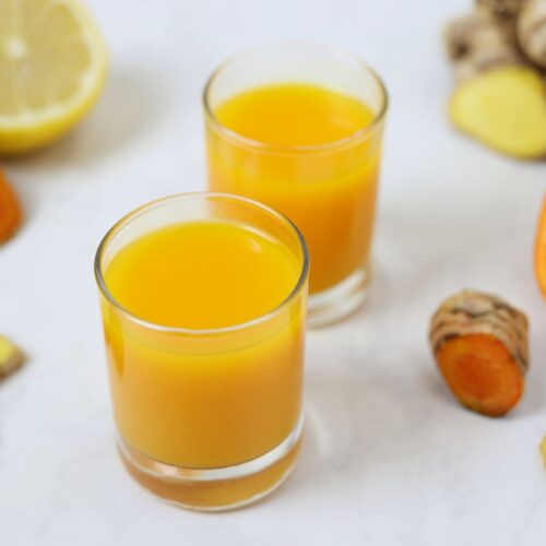 ginger turmeric immune shots surrounded by ingredients