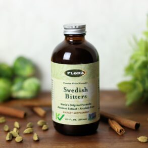 A bottle of Swedish Bitters from Flora surrounded by ingredients.