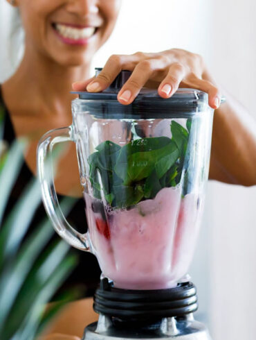 A woman makes a healthy smoothie