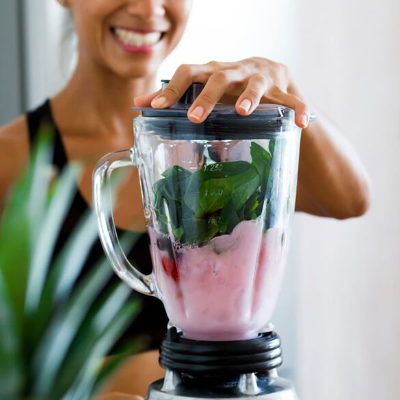 A woman makes a healthy smoothie