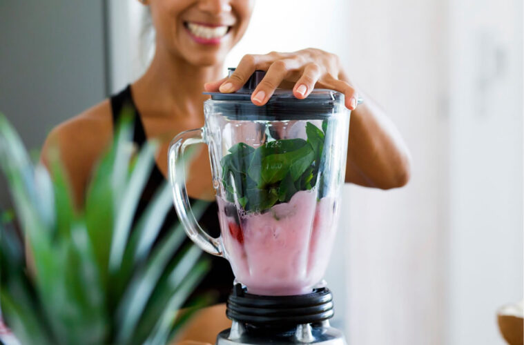 A woman makes a healthy smoothie