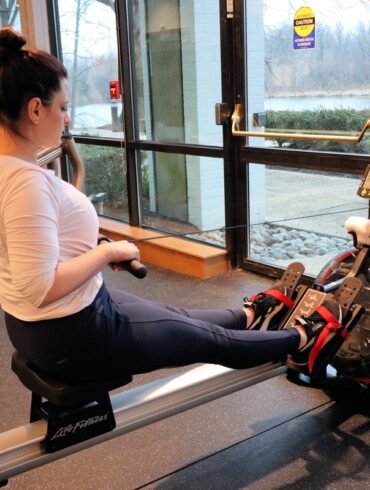 Heather from Better Living on a rowing machine at the fitness center at the Merriweather Lakehouse Hotel