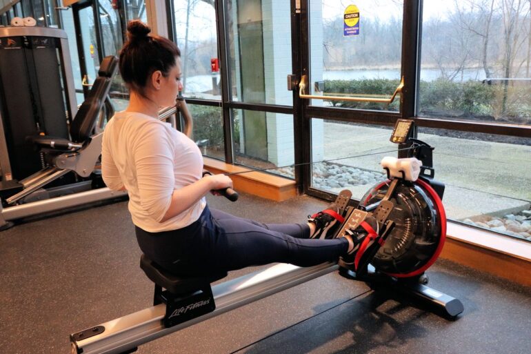 Heather from Better Living on a rowing machine at the fitness center at the Merriweather Lakehouse Hotel