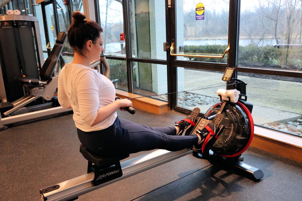 Heather from Better Living on a rowing machine at the fitness center at the Merriweather Lakehouse Hotel