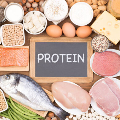 A selection of lean protein sources on a table including fish, chicken, eggs, tofu, legumes, and more.