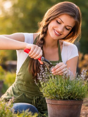a woman gardening around potted plants in early morning light during allergy season.