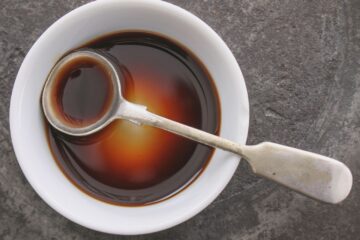 Worcestershire Sauce in a bowl with a spoon.