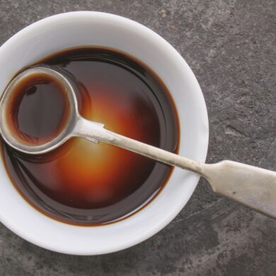 Worcestershire Sauce in a bowl with a spoon.