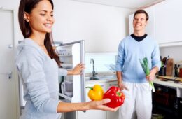 A couple stocks their fridge with healthy foods to help weight loss.