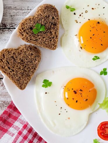 Heart shaped eggs and toast on a plate