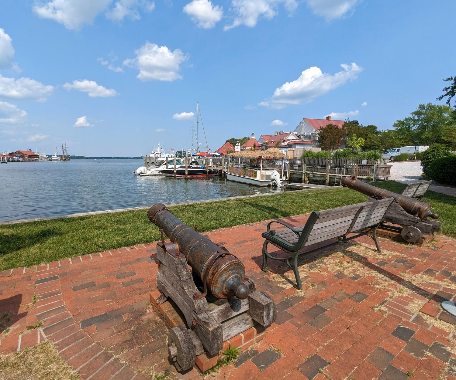 A bench and canon overlooking the marina at Muskrat Park in St. Michaels, MD.