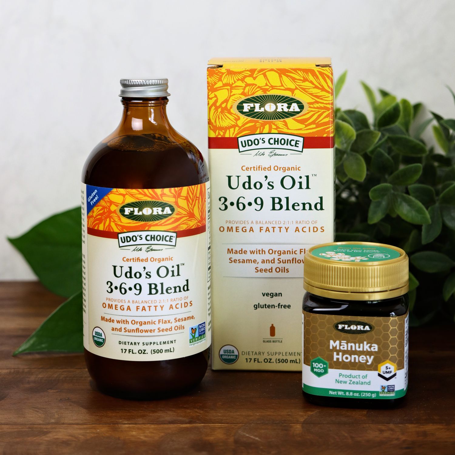 a bottle of udos oil and a jar of manuka honey from flora