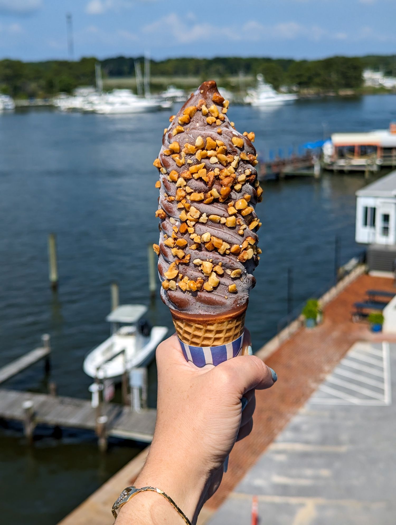 The famous Kent Narrows Nutty Buddy ice cream cone being held high above the bay.