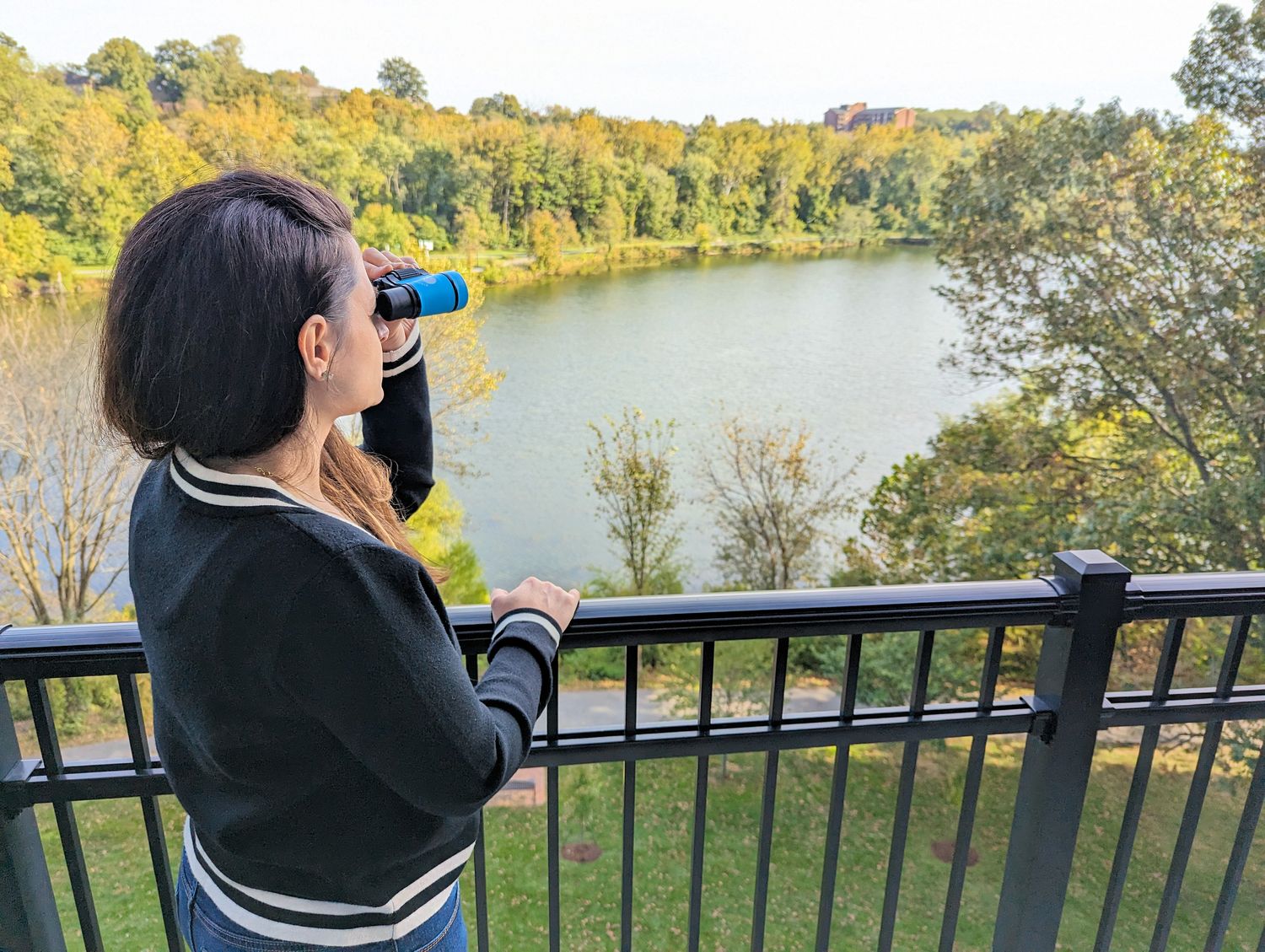 Heather from Better Living birdwatching from the balcony of a lakefront Birdsong Society Suite at Merriweather Lakehouse Hotel