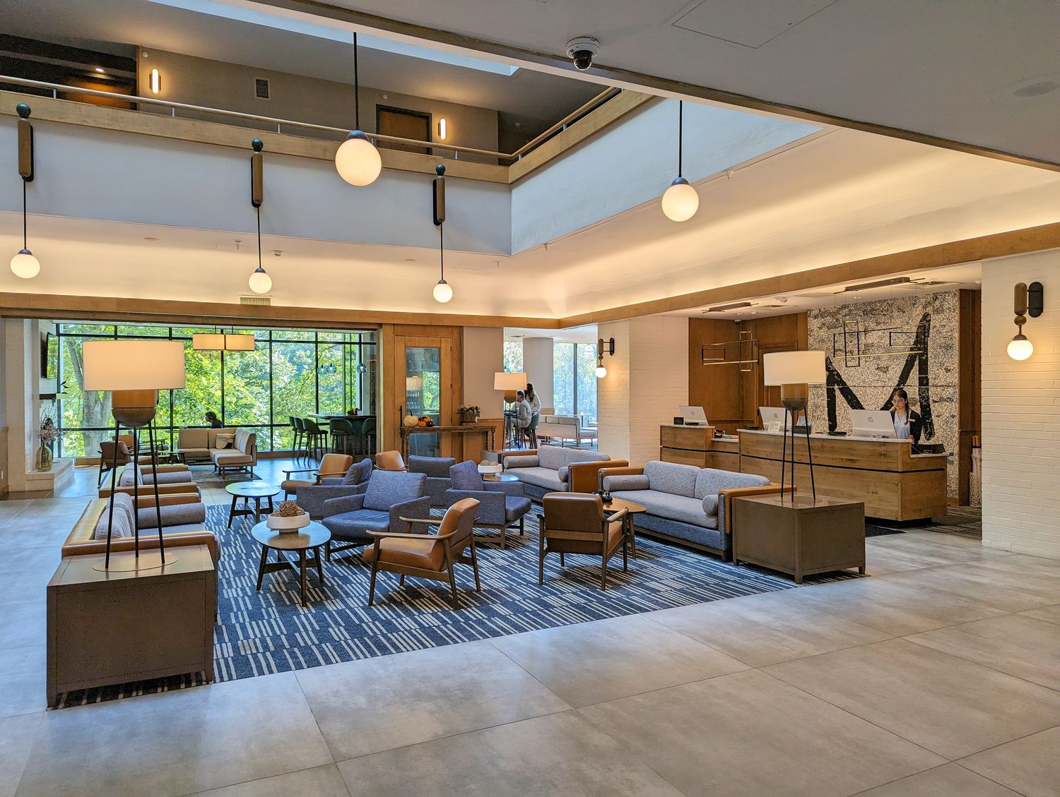 The open lobby at Merriweather Lakehouse Hotel includes a check in desk with plenty of couch and chair seating. 