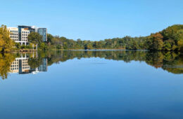 A view of the water and trees in early fall of Lake Kittamaqundi in Columbia, MD.