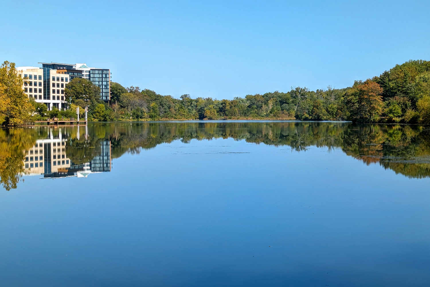 A view of the water and trees in early fall of Lake Kittamaqundi in Columbia, MD.