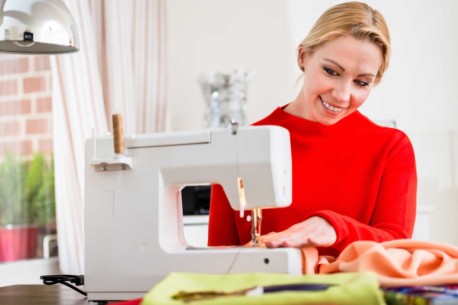 a woman crafting with upholstery fabric on a sewing machine