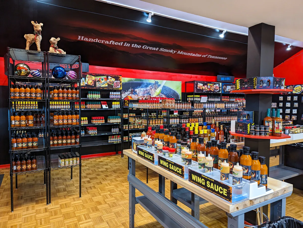A wide shot of of the Pepper Palace store featuring hundreds of sauces on shelves and tables. 